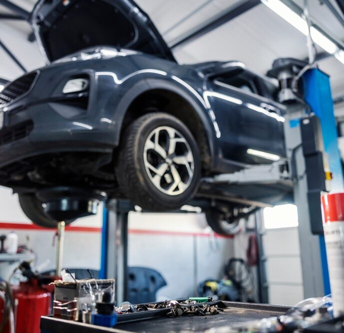 a car on a lift in a garage