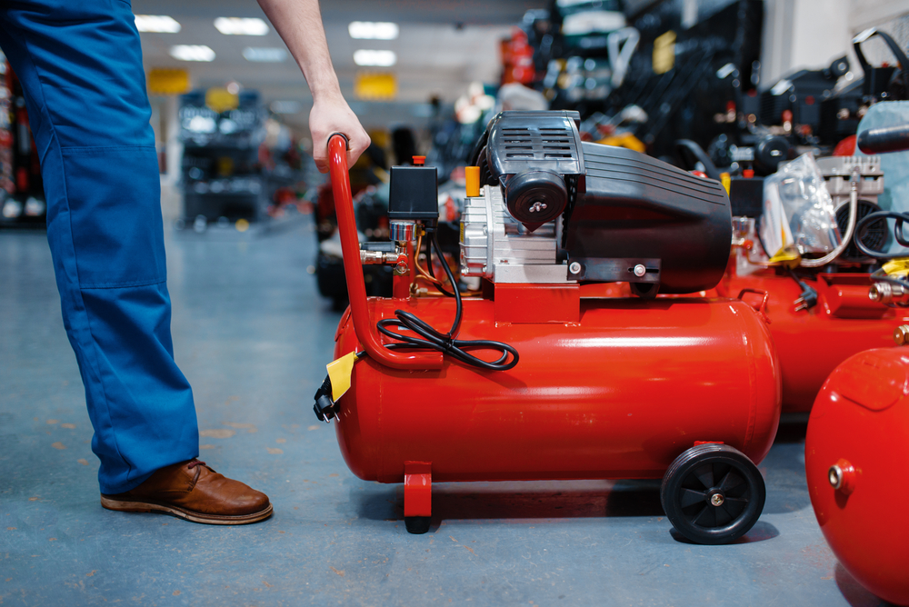 man purchasing an air compressor at the store